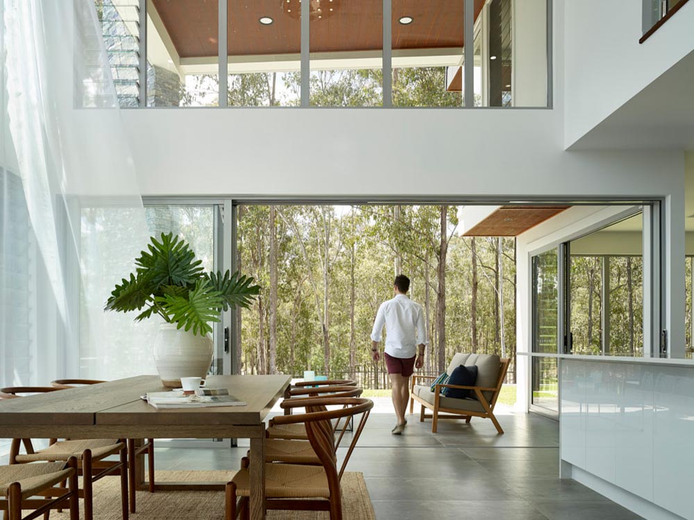 A man walking in his home.