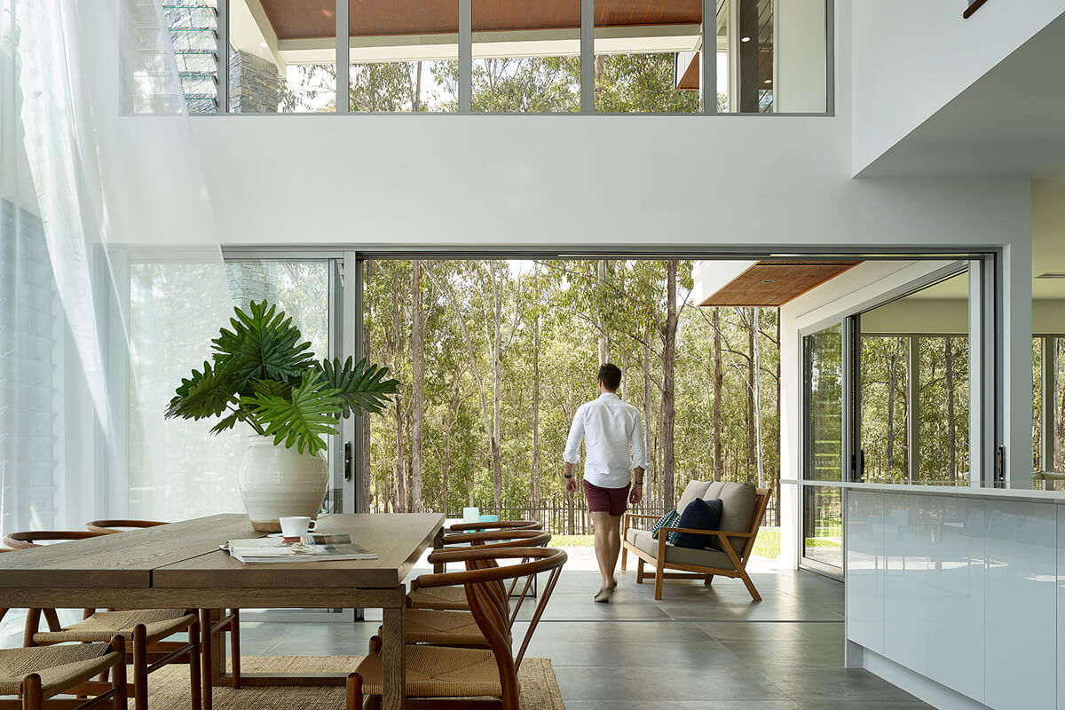 Mother and father with their son outdoors on the field laughing | Featured image for the Modern Urban Living – What Buyers Are Looking for in 2025 blog from Brookwater Residential.